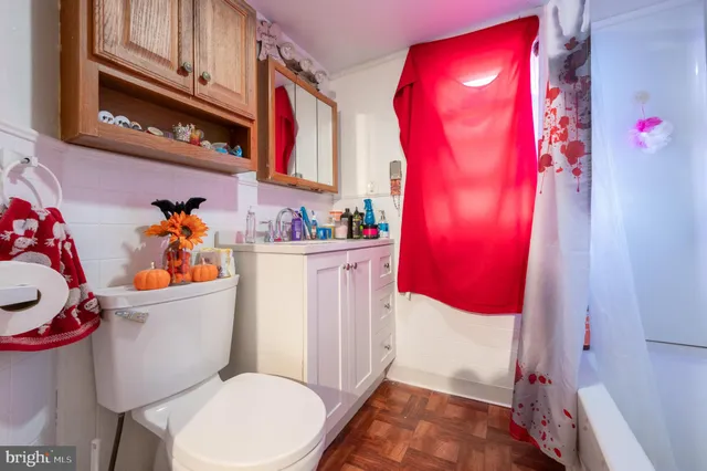 a bathroom with a sink toilet and mirror
