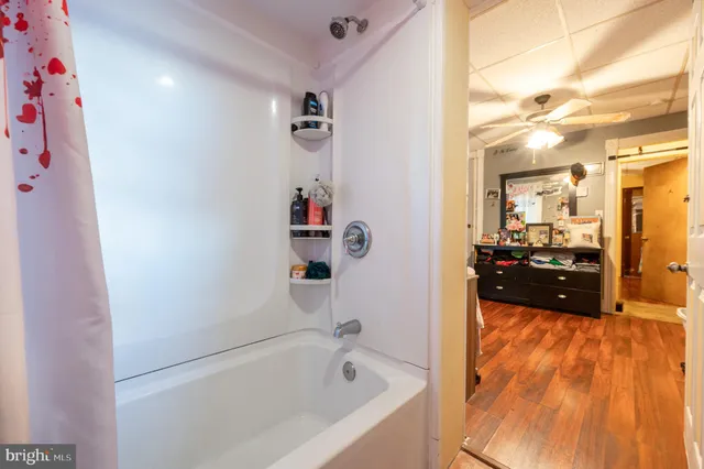 a bathroom with a bathtub and a shower