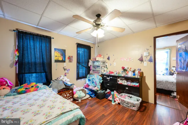a bedroom with furniture and a wooden floor
