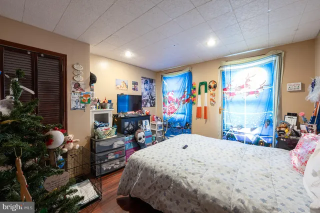 a bed room with a bed a couch and potted plant