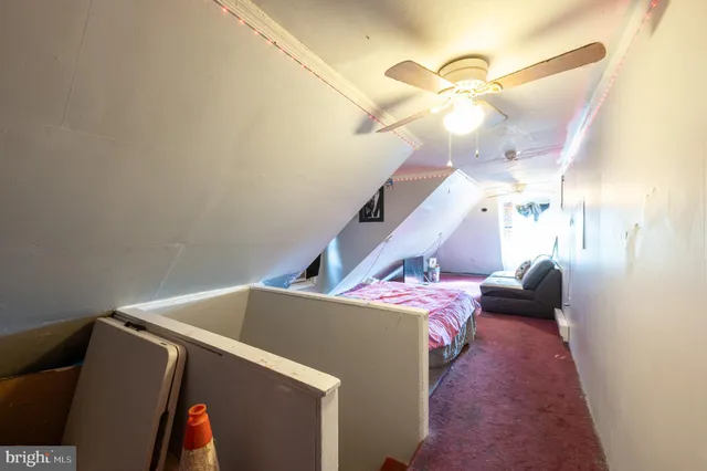 a bedroom with a bed and a ceiling fan