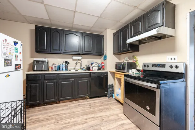 a kitchen with a stove cabinets and microwave