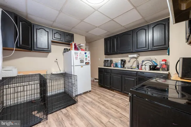 a kitchen with stainless steel appliances granite countertop a refrigerator and wooden cabinets