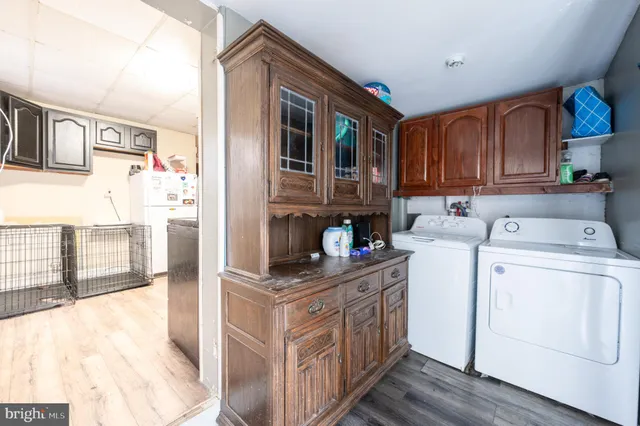 a utility room with cabinets washer and dryer