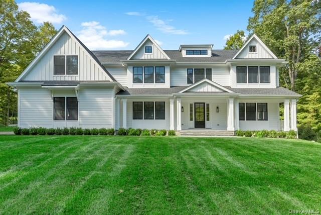 115 Old Roaring Brook Road Mount Kisco, NY 10549 - Photo 8 of 25 a front view of a house with a garden