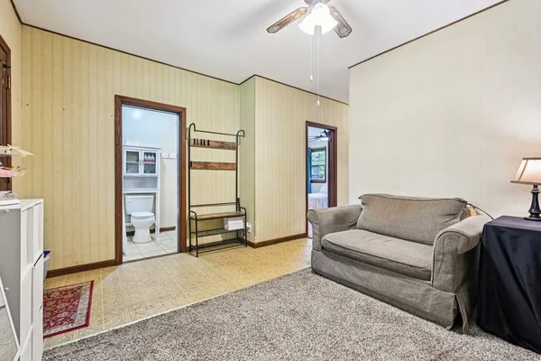 a bedroom with a bed and a wooden floor