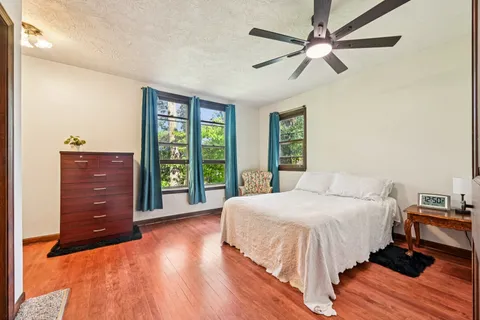 a bedroom with a bed and a mirror