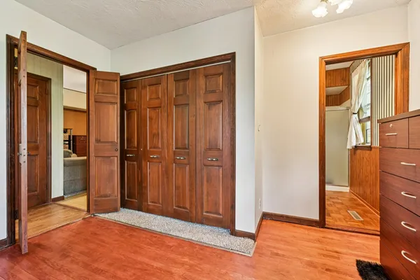 a room with a bed and a book shelf