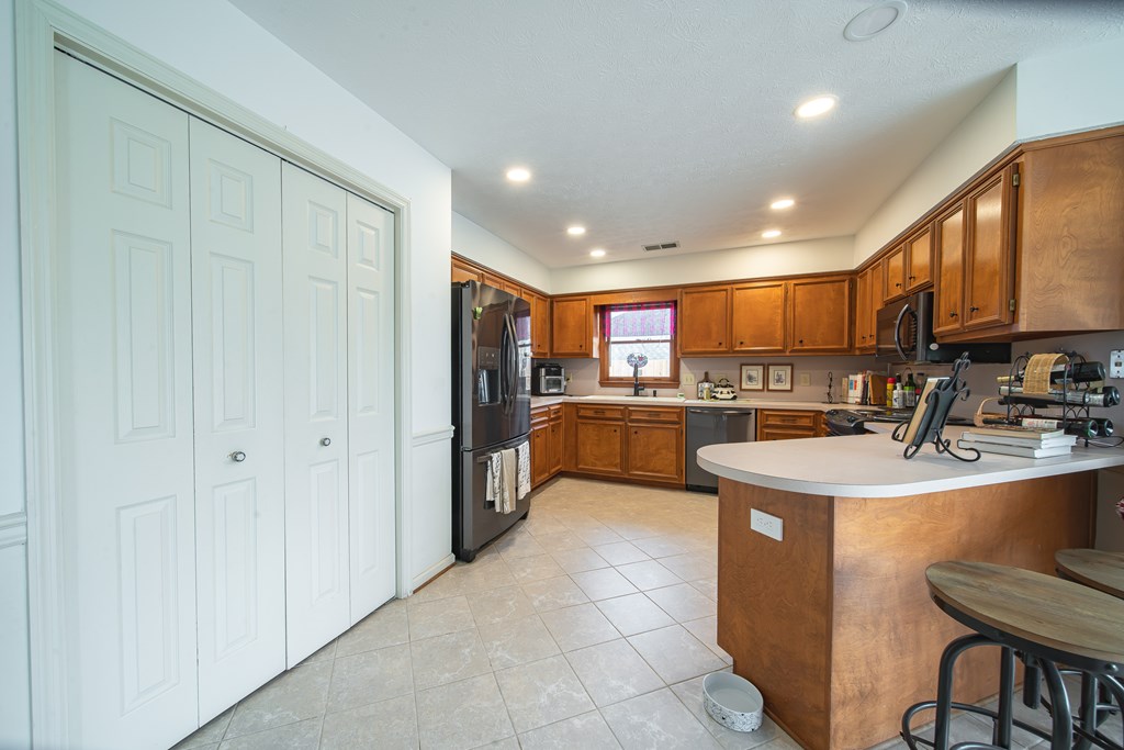 4856 Spring Ridge Drive Columbus, GA 31909 - Photo 14 of 41 a kitchen with stainless steel appliances granite countertop a sink refrigerator and cabinets