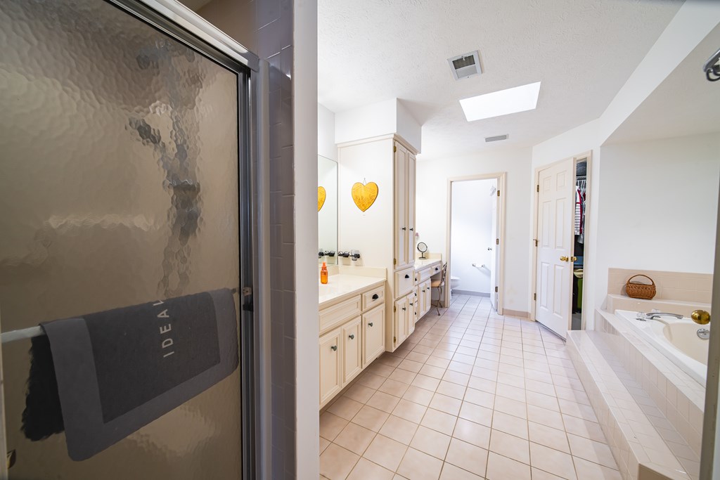 4856 Spring Ridge Drive Columbus, GA 31909 - Photo 23 of 41 a bathroom with a double vanity sink and mirror with shower