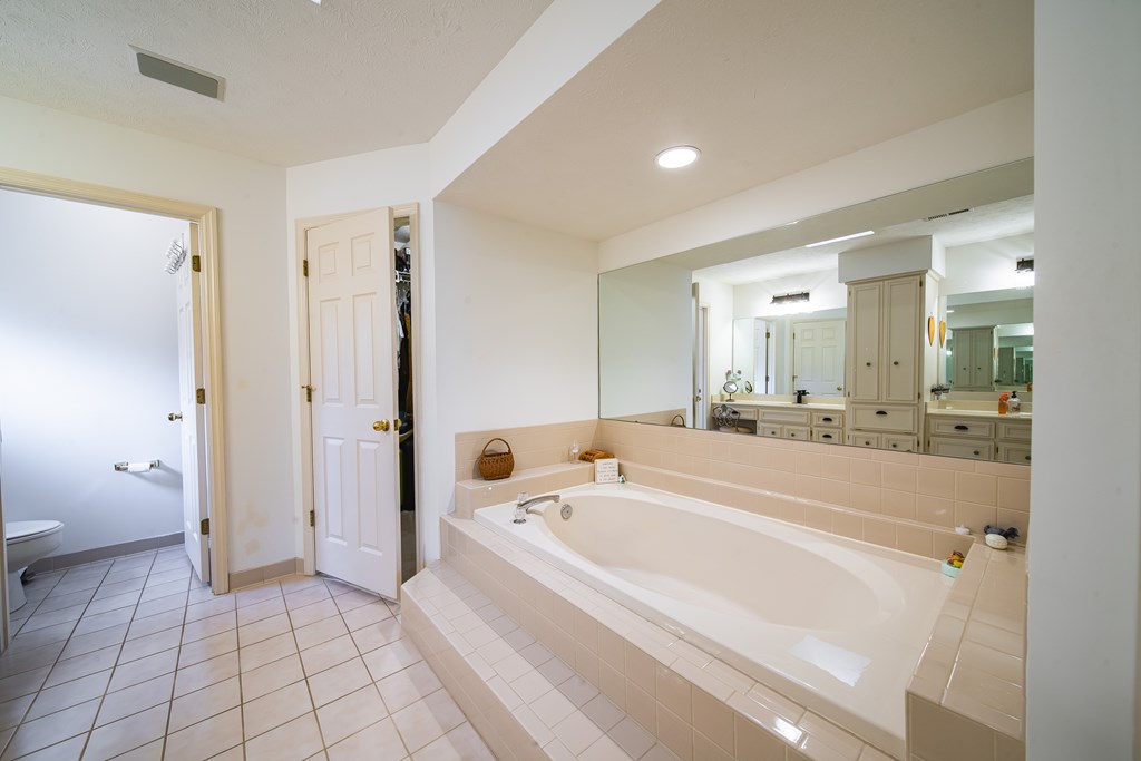 4856 Spring Ridge Drive Columbus, GA 31909 - Photo 24 of 41 a spacious bathroom with a tub shower and bedroom