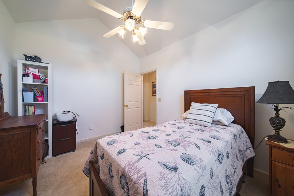 4856 Spring Ridge Drive Columbus, GA 31909 - Photo 31 of 41 a bedroom with a bed and a chandelier