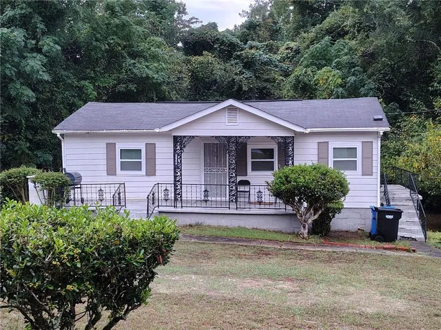 a front view of a house with a yard and porch
