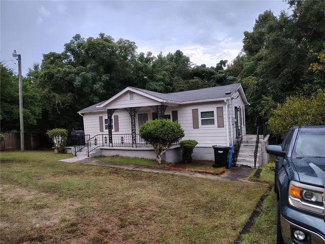 a front view of a house with garden