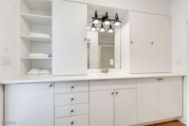 a bathroom with a sink and cabinets