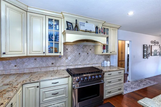a kitchen with stainless steel appliances granite countertop a stove and a cabinet