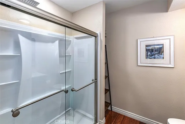a bathroom with a glass shower door