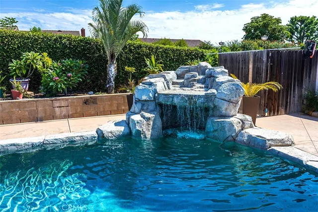 a view of a backyard with plants and patio