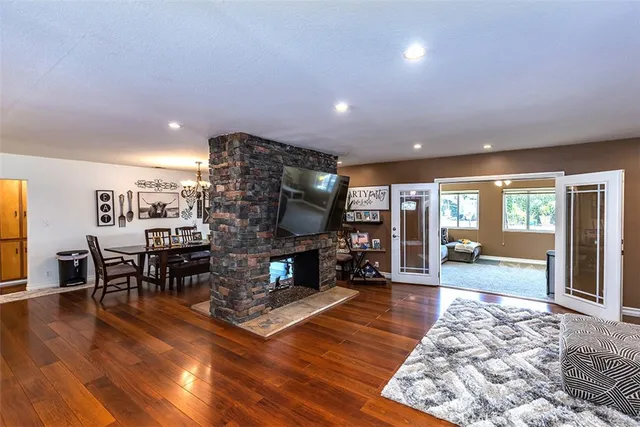 a living room with furniture a large window and a fireplace