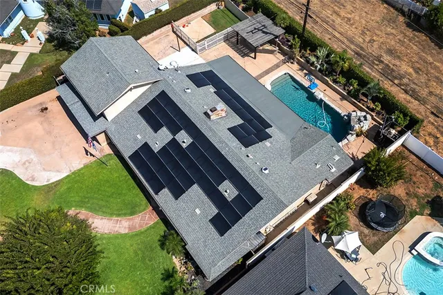 an aerial view of a house with a garden and trees
