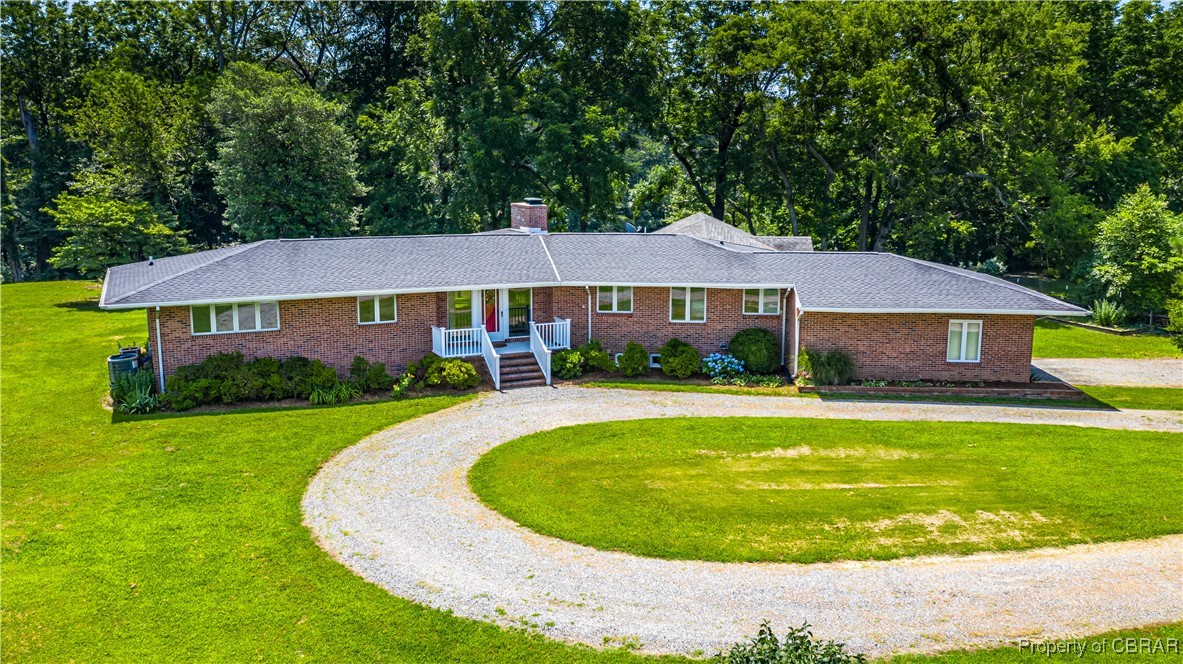 86 Greenfield Road Lancaster, VA 22503 - Photo 2 of 44 Ranch-style house with curved driveway, a front lawn, brick siding, and a chimney