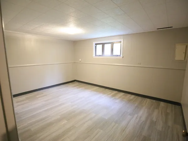 a view of a room with wooden floor and white walls