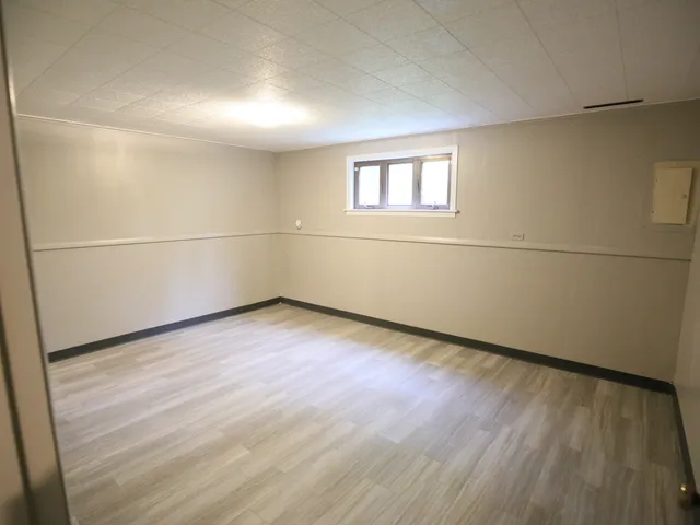 a view of a room with wooden floor and white walls