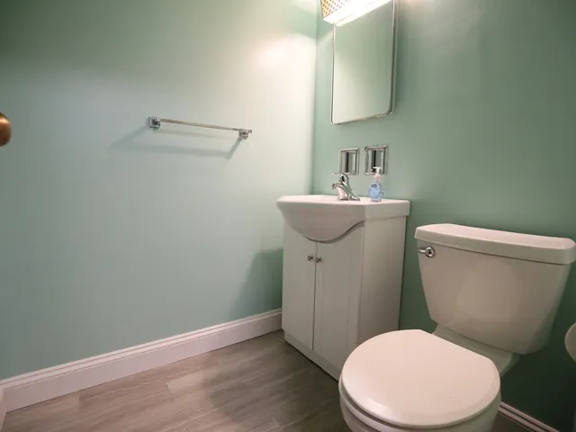 a white toilet sitting next to a bathroom sink
