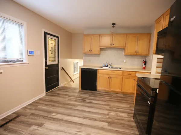 a kitchen with stainless steel appliances granite countertop a sink and cabinets