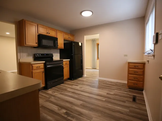 a kitchen with stainless steel appliances a stove and a refrigerator