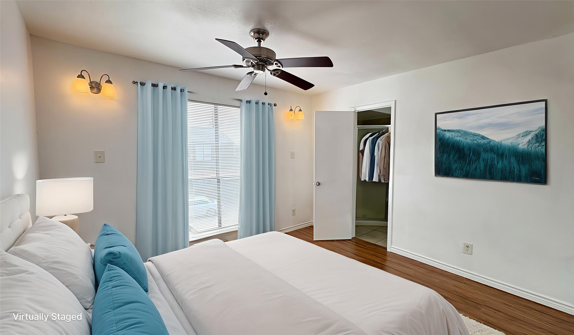 6633 West Airport Boulevard, Unit 101 Houston, TX 77035 - Photo 13 of 25 a bedroom with a large bed and a chandelier