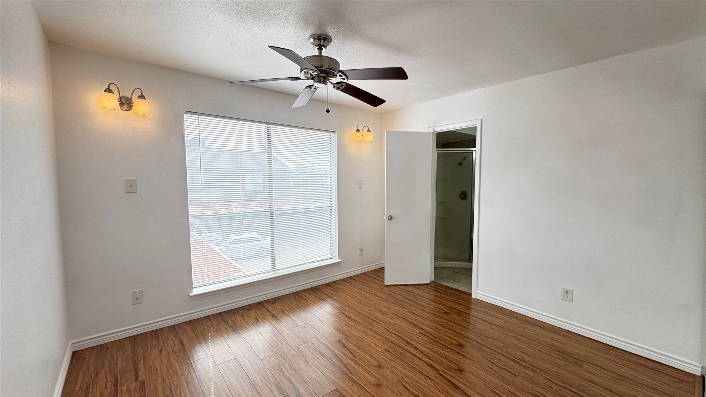 6633 West Airport Boulevard, Unit 101 Houston, TX 77035 - Photo 14 of 25 a view of empty room with wooden floor and fan