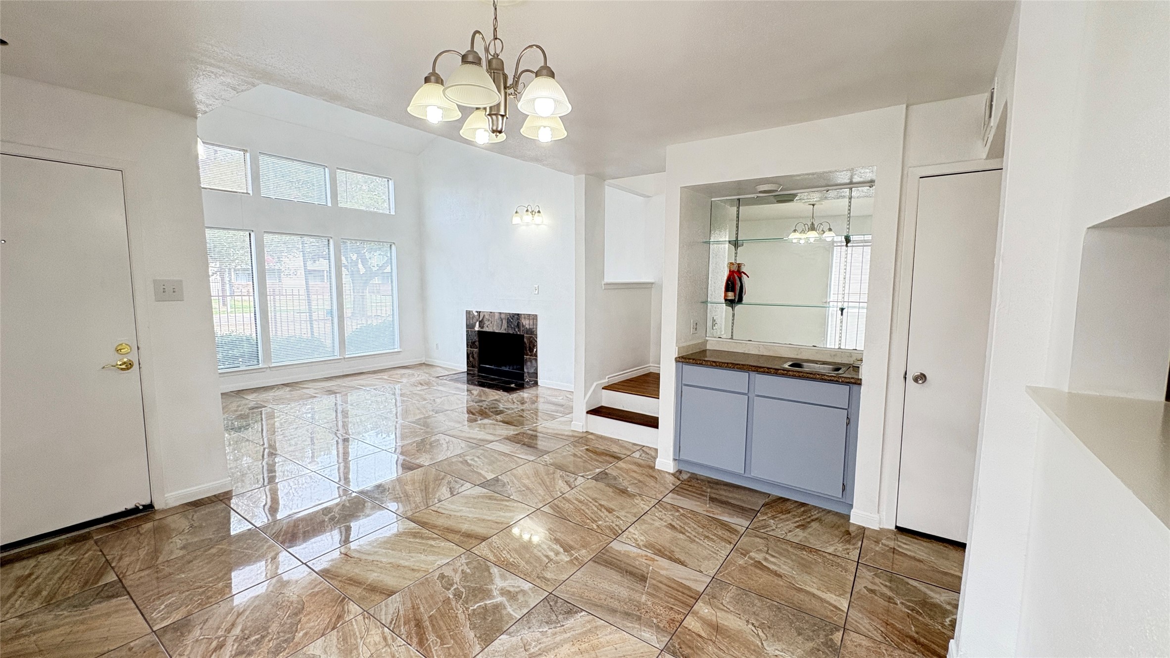 6633 West Airport Boulevard, Unit 101 Houston, TX 77035 - Photo 5 of 25 a living room with stainless steel appliances kitchen island granite countertop furniture and a fireplace