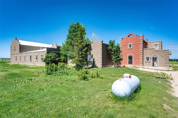 a view of a house with a backyard and a fire pit