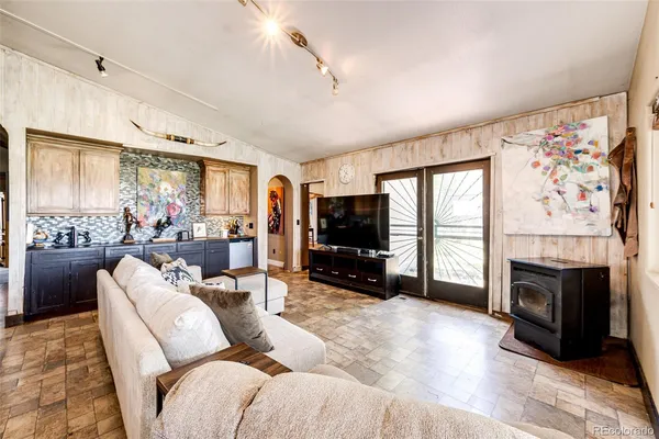 a living room with furniture large window and a flat screen tv