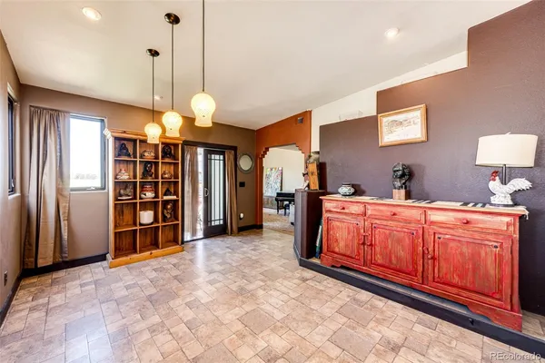 a large kitchen with stainless steel appliances granite countertop a refrigerator a oven and a sink with large cabinets