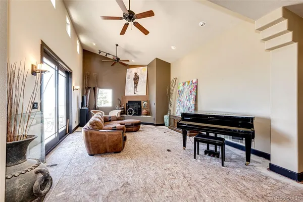 a living room with furniture and a piano