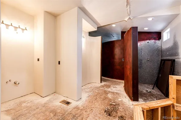 a view of a hallway with wooden cabinets