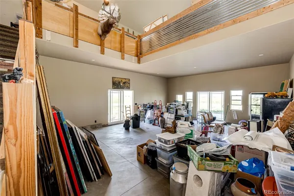 a very nice looking room with many windows and furniture