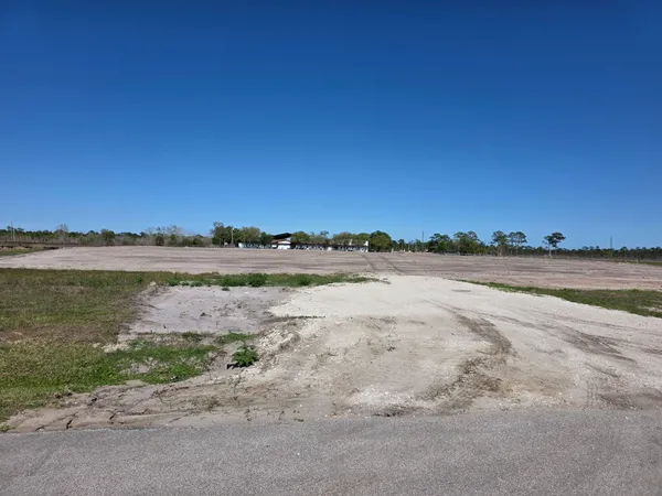 a view of a lake with beach and city view