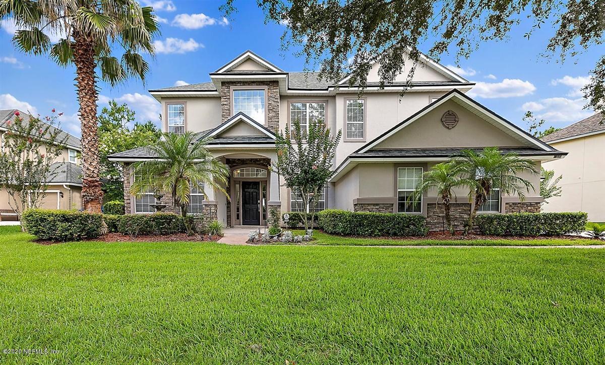 1320 Powis Road St. Augustine, FL 32095 - Photo 1 of 32 a front view of a house with a yard and garage