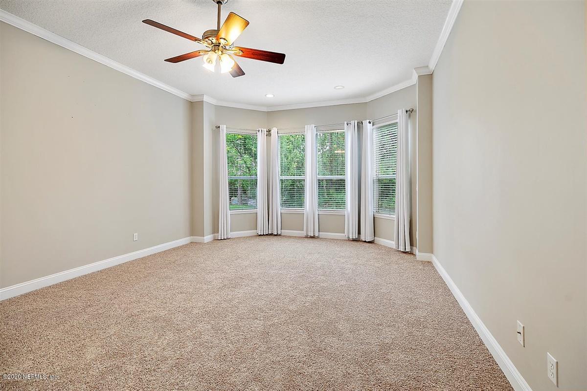 1320 Powis Road St. Augustine, FL 32095 - Photo 14 of 32 an empty room with a ceiling fan and a window