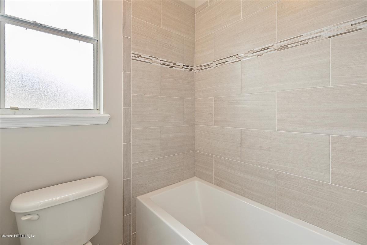 1320 Powis Road St. Augustine, FL 32095 - Photo 22 of 32 a white bath tub sitting next to a toilet