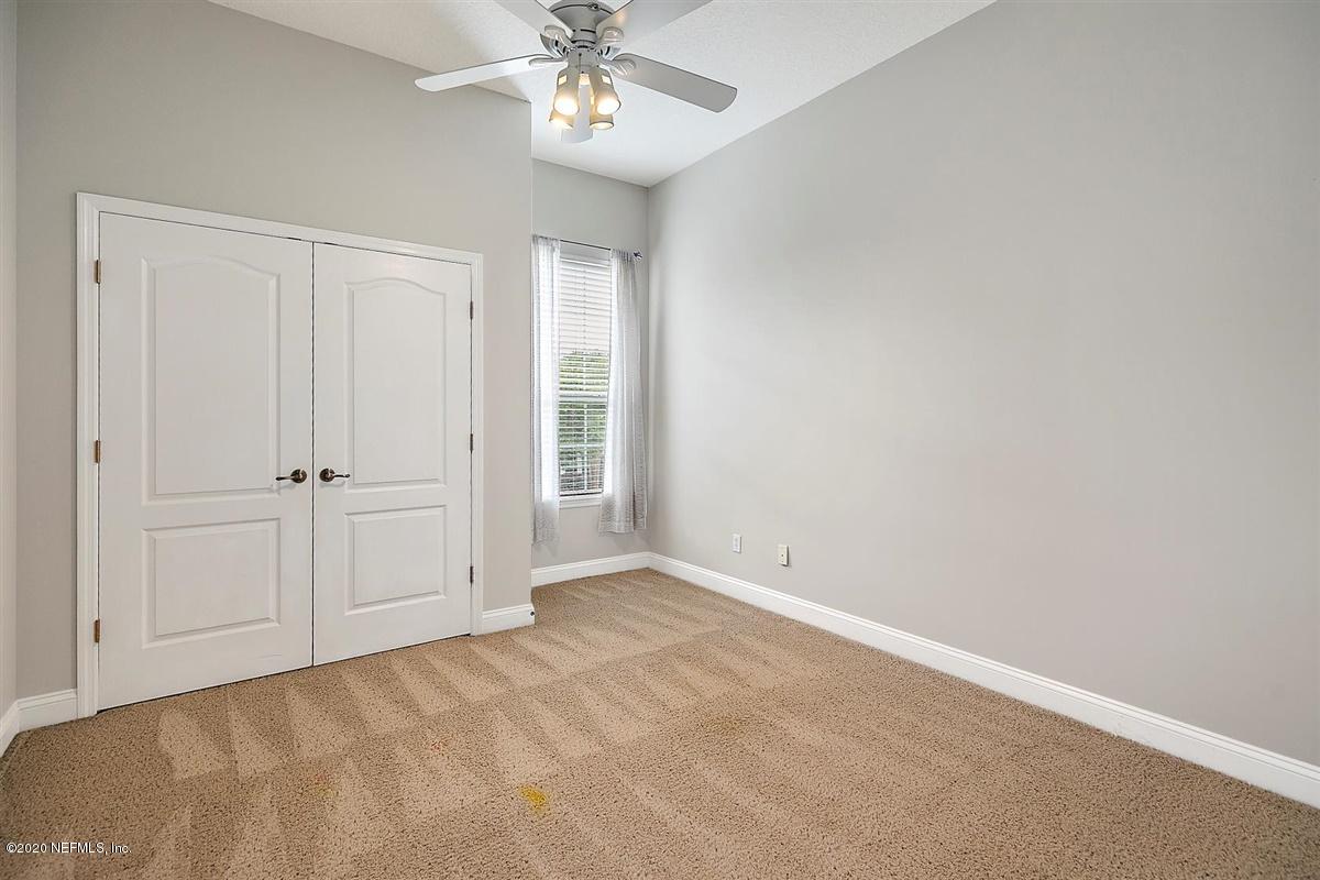 1320 Powis Road St. Augustine, FL 32095 - Photo 24 of 32 an empty room with a chandelier fan