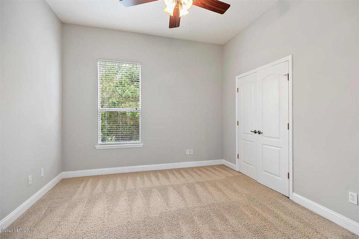 1320 Powis Road St. Augustine, FL 32095 - Photo 26 of 32 an empty room with a window and a chandelier fan