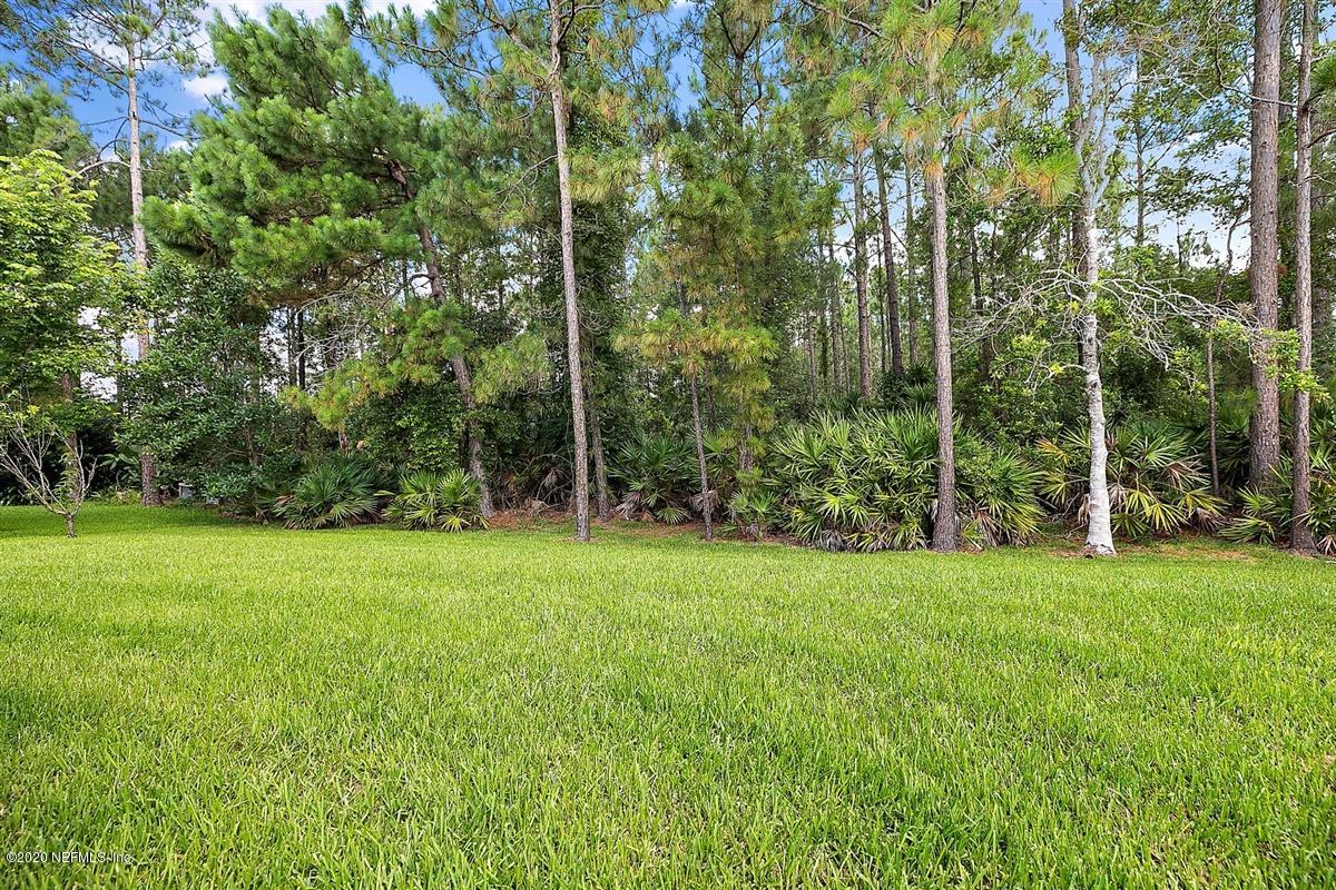 1320 Powis Road St. Augustine, FL 32095 - Photo 28 of 32 a view of a grassy field with trees in the background