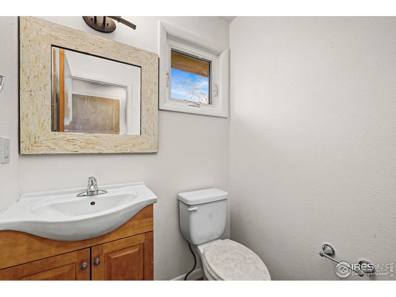 805 Colorado Street Fort Collins, CO 80524 - Photo 26 of 45 a bathroom with a toilet sink and mirror