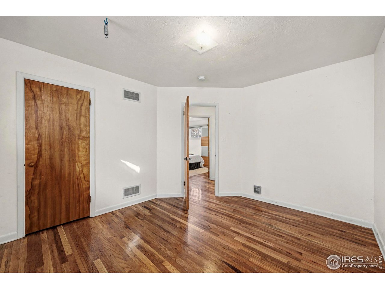 805 Colorado Street Fort Collins, CO 80524 - Photo 29 of 45 a view of an empty room with wooden floor