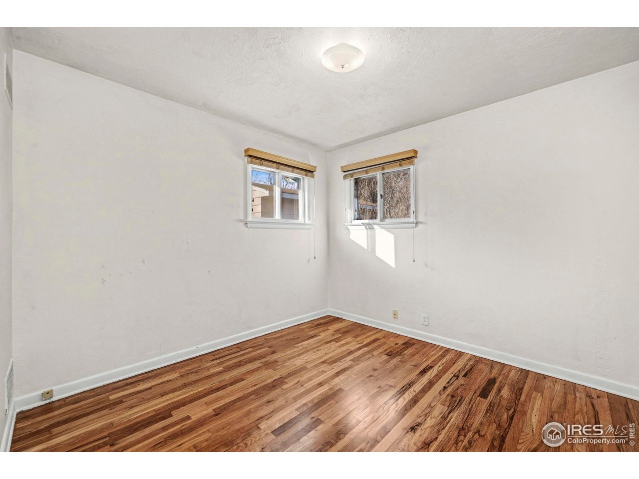 805 Colorado Street Fort Collins, CO 80524 - Photo 30 of 45 a view of an empty room with wooden floor and a window