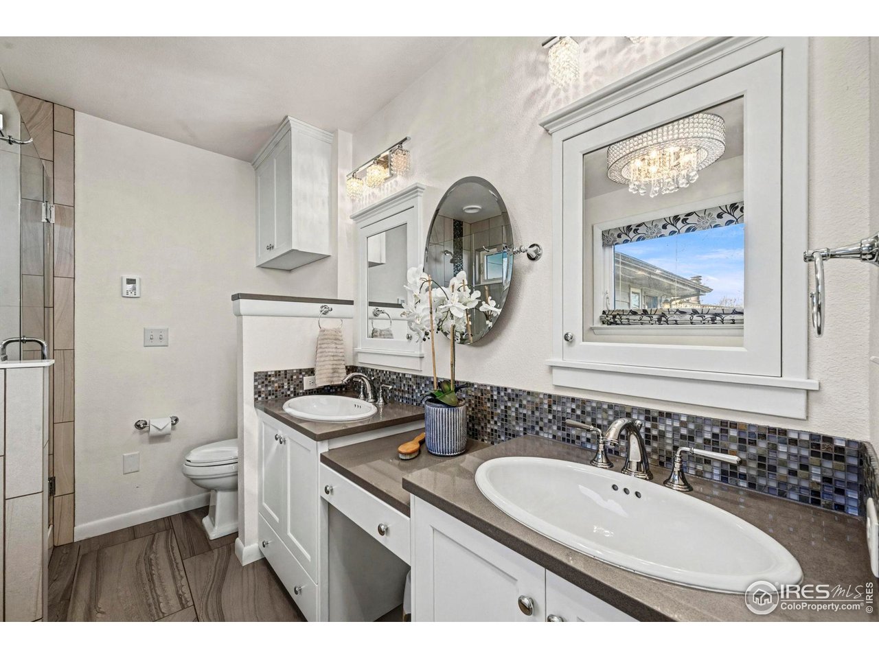 805 Colorado Street Fort Collins, CO 80524 - Photo 34 of 45 a bathroom with a granite countertop toilet a sink and mirror